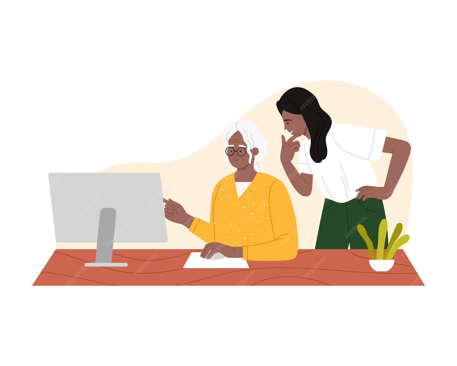 Une grand-mère avec des lunettes apprend à utiliser l’ordinateur avec l’aide de sa petite-fille.